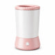 pet paw cleaner cup pink and white, featuring a textured pink lid and base with a power button icon on the front, set against a plain white background.